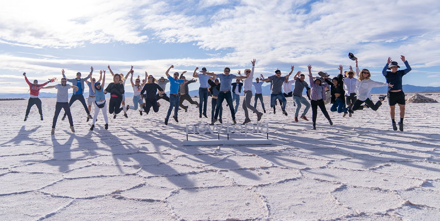 Many people jumping into the air off salt flats in Purmamarca after pitching investors